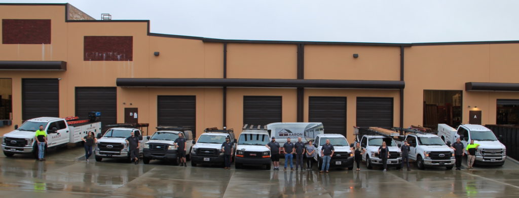 Aaron Overhead Doors Employees Standing in front of companies truck. 